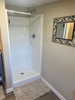 bathroom featuring a shower and hardwood / wood-style floors