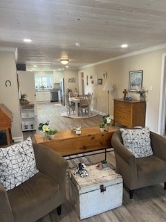 living room with crown molding and hardwood / wood-style floors