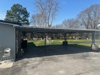 view of parking featuring a lawn and a carport