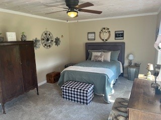 carpeted bedroom featuring crown molding and ceiling fan