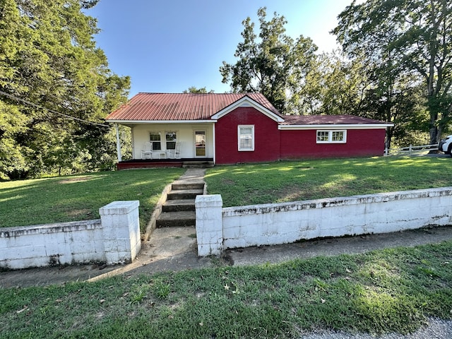 single story home with a porch and a front lawn