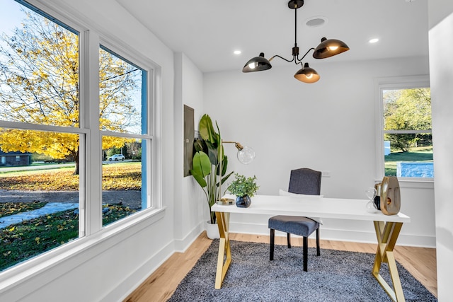 office featuring light hardwood / wood-style flooring and a notable chandelier