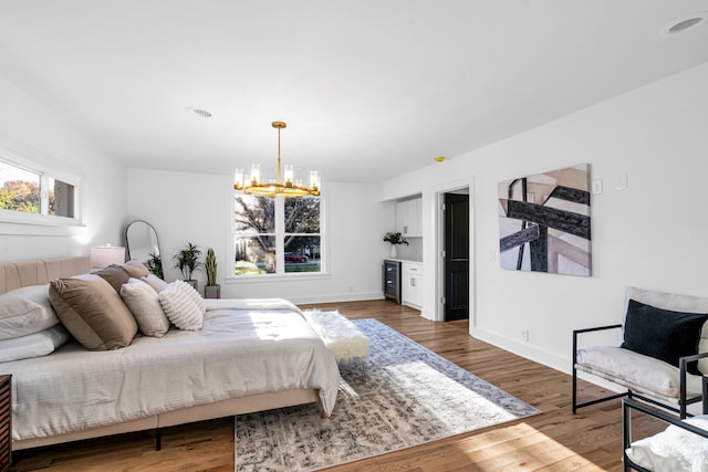 bedroom featuring hardwood / wood-style flooring and a notable chandelier