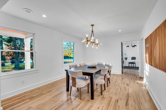 dining room with an inviting chandelier and light hardwood / wood-style flooring