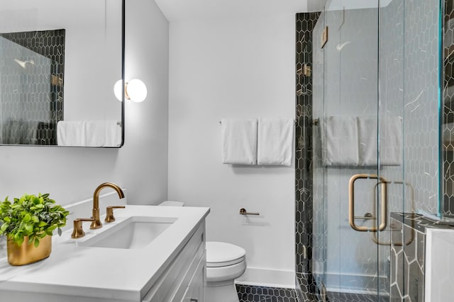 bathroom featuring tile patterned floors, vanity, toilet, and an enclosed shower