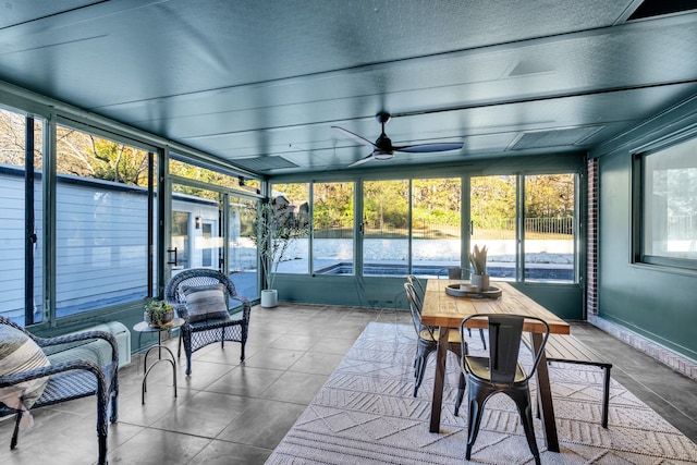 sunroom featuring ceiling fan