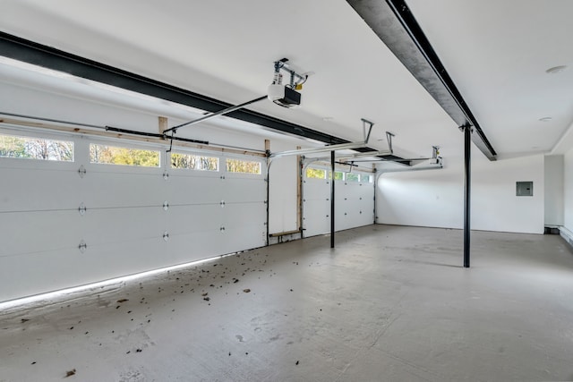 garage featuring electric panel and a garage door opener