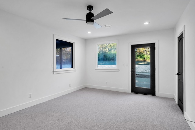 carpeted empty room featuring ceiling fan