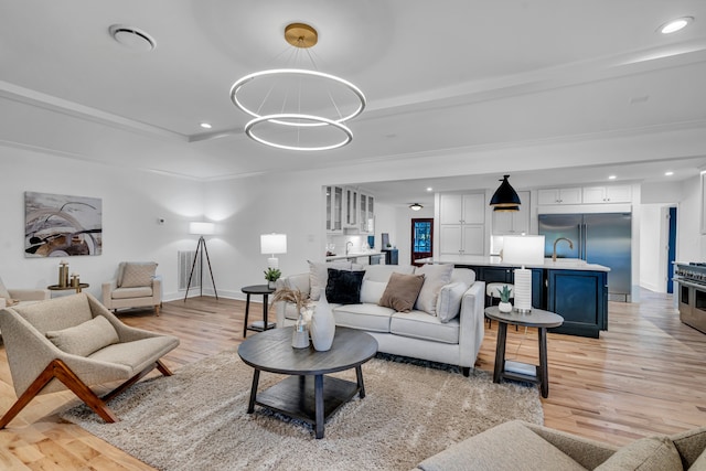 living room featuring light hardwood / wood-style floors and a notable chandelier