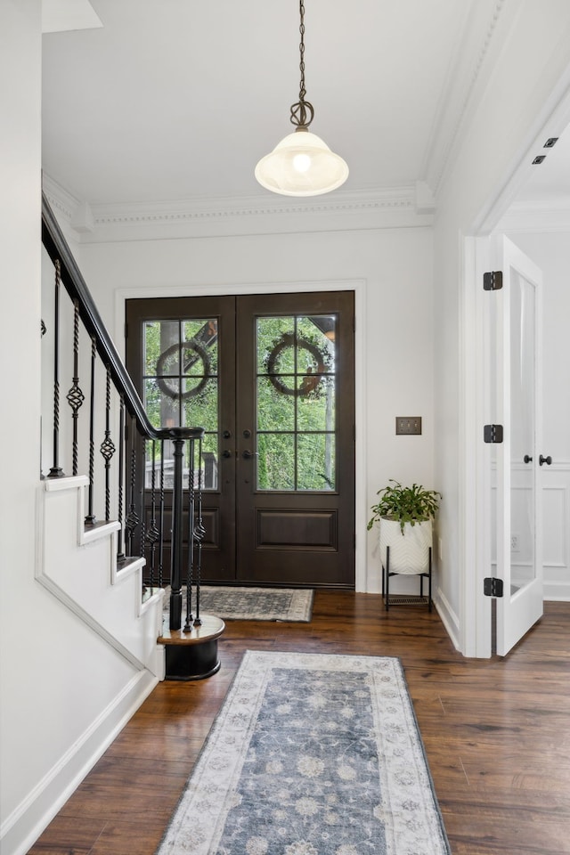 entryway featuring crown molding, dark hardwood / wood-style flooring, and french doors