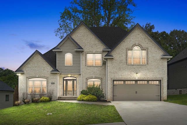 french country inspired facade featuring a lawn and a garage