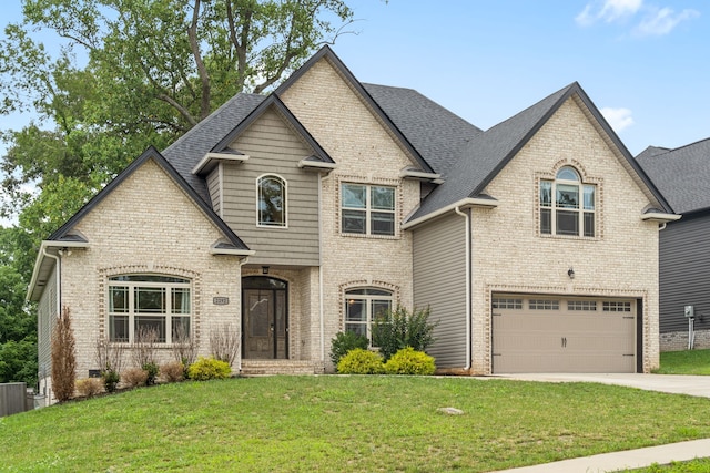 view of front of property featuring a garage and a front lawn