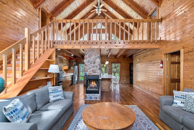 living room featuring wooden walls, wooden ceiling, beamed ceiling, and dark hardwood / wood-style flooring