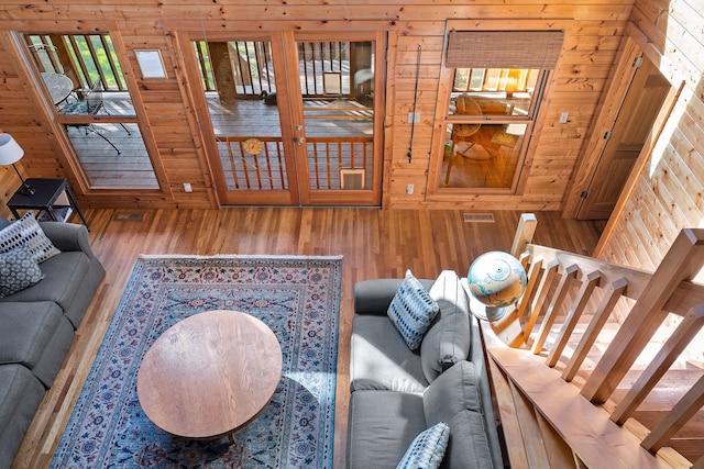 living room featuring wooden walls and wood-type flooring