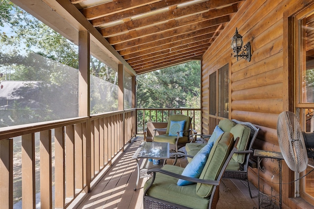 sunroom featuring lofted ceiling