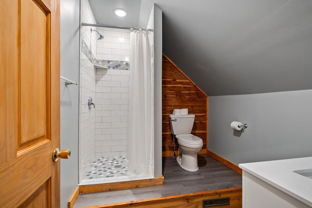 bathroom featuring wood-type flooring, a shower with curtain, wood walls, and toilet