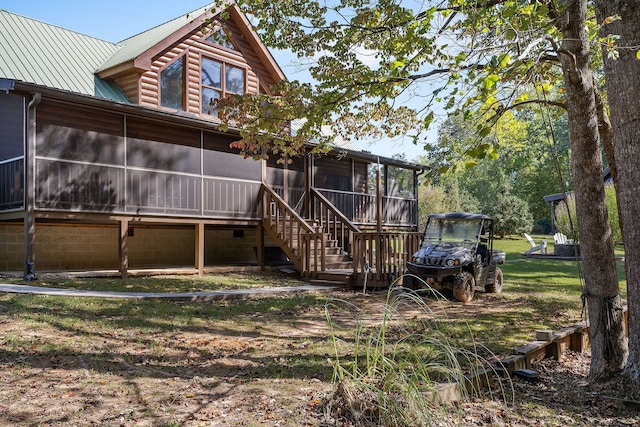 rear view of property with a sunroom