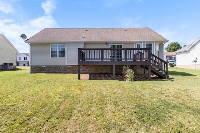 rear view of property with a wooden deck, central AC, and a yard