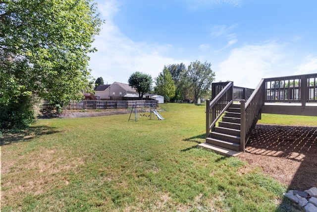 view of yard with a playground and a deck