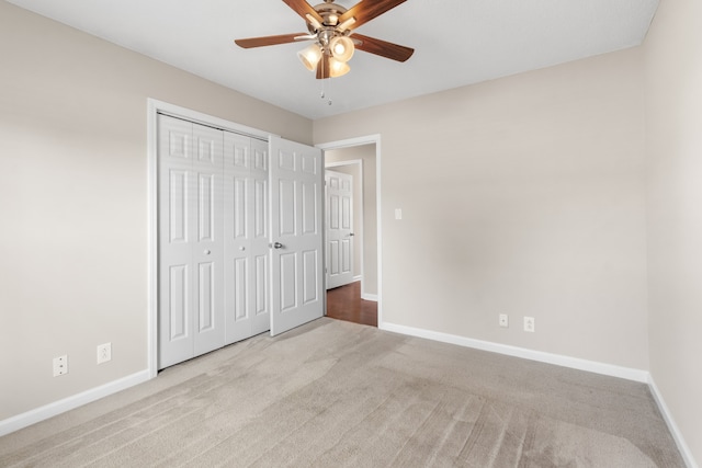 unfurnished bedroom with light carpet, ceiling fan, and a closet