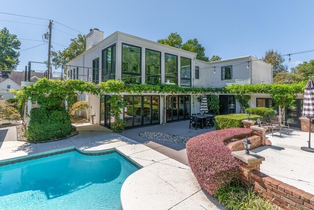 back of property with a patio