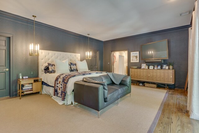 bedroom featuring ornamental molding and hardwood / wood-style floors