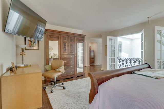 bedroom featuring crown molding and dark hardwood / wood-style flooring