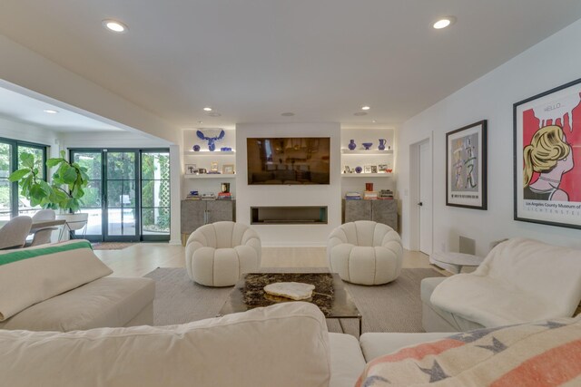 living room featuring a fireplace and built in shelves