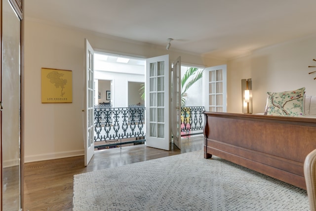 bedroom with hardwood / wood-style flooring, a closet, and ornamental molding