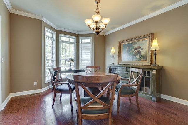 dining area with crown molding, dark wood-type flooring, and a chandelier