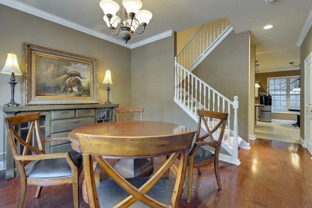 dining area featuring a notable chandelier, ornamental molding, and hardwood / wood-style flooring