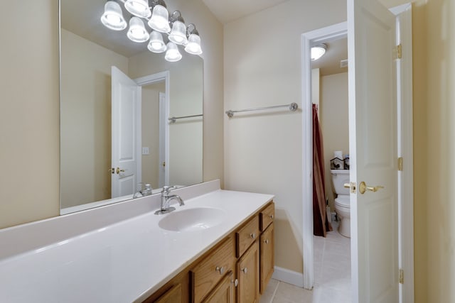 bathroom featuring tile patterned floors, vanity, and toilet