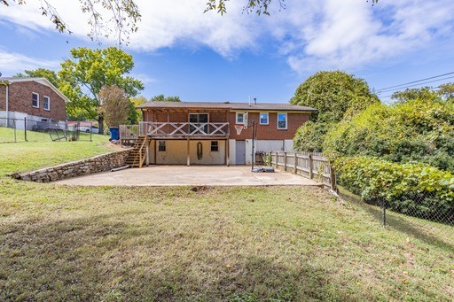 rear view of house with a lawn and a patio area