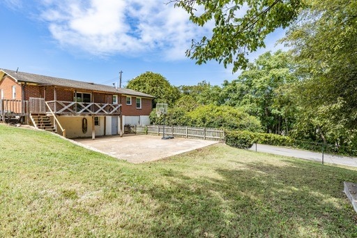 view of yard featuring a deck and a patio area