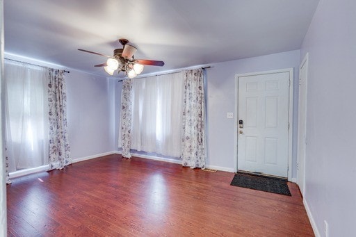 foyer with ceiling fan and dark hardwood / wood-style flooring