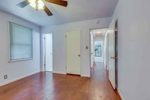 unfurnished bedroom with ceiling fan and hardwood / wood-style flooring