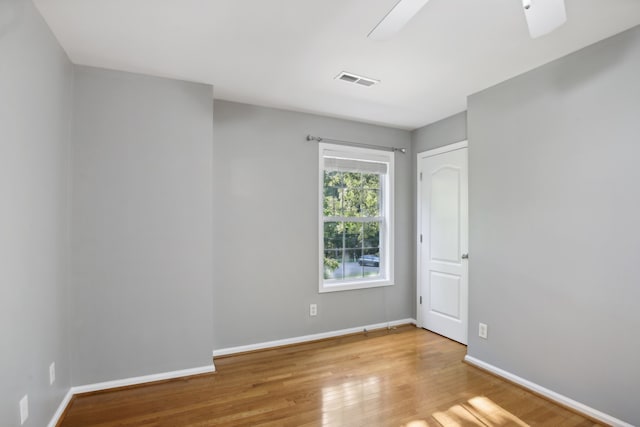 spare room with ceiling fan and light wood-type flooring