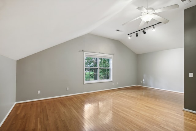 additional living space with vaulted ceiling, light hardwood / wood-style floors, and ceiling fan