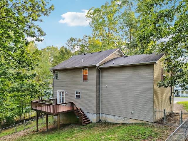 rear view of property with a yard and a deck