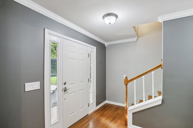 entryway featuring ornamental molding and hardwood / wood-style floors