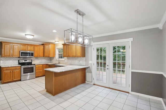 kitchen with pendant lighting, crown molding, stainless steel appliances, and kitchen peninsula