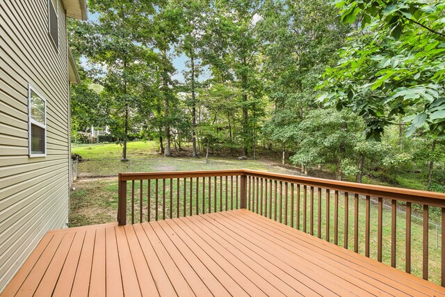 wooden deck featuring a yard