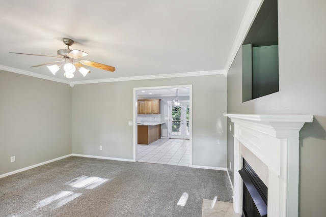 unfurnished living room with ceiling fan, light colored carpet, ornamental molding, and a high end fireplace