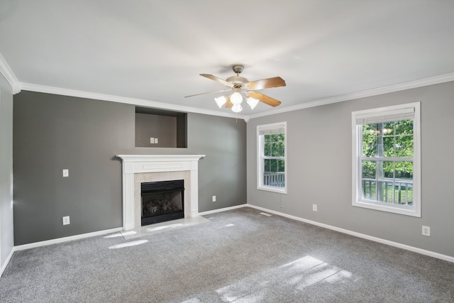 unfurnished living room with crown molding, a fireplace, carpet floors, and a wealth of natural light