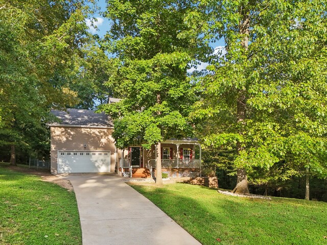 obstructed view of property with a garage and a front lawn