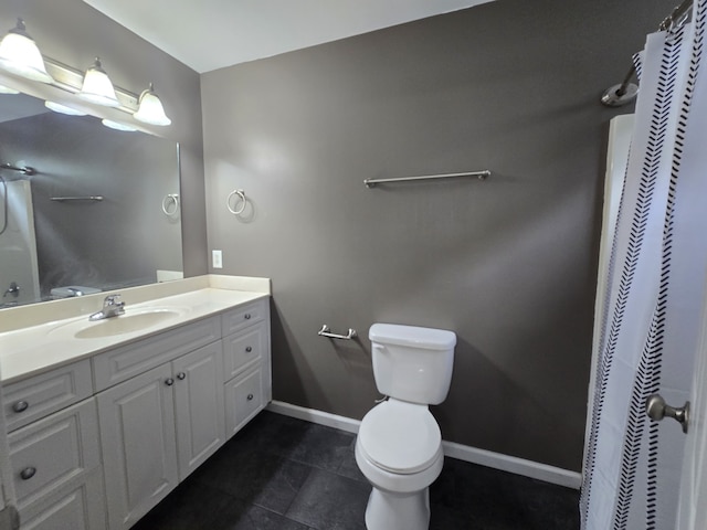 bathroom with tile patterned flooring, vanity, and toilet