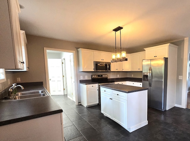 kitchen with white cabinets, pendant lighting, sink, stainless steel appliances, and a center island