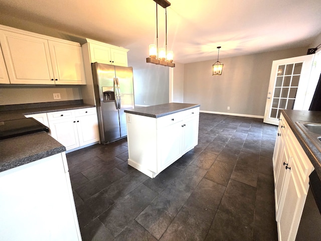 kitchen featuring pendant lighting, white cabinets, stainless steel refrigerator with ice dispenser, and a kitchen island