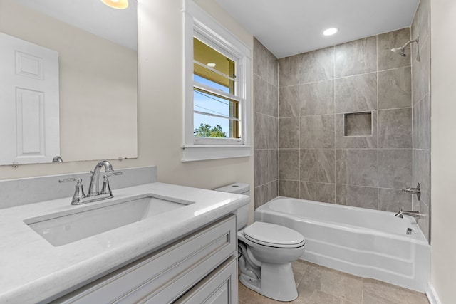 full bathroom with vanity, tiled shower / bath combo, toilet, and tile patterned floors