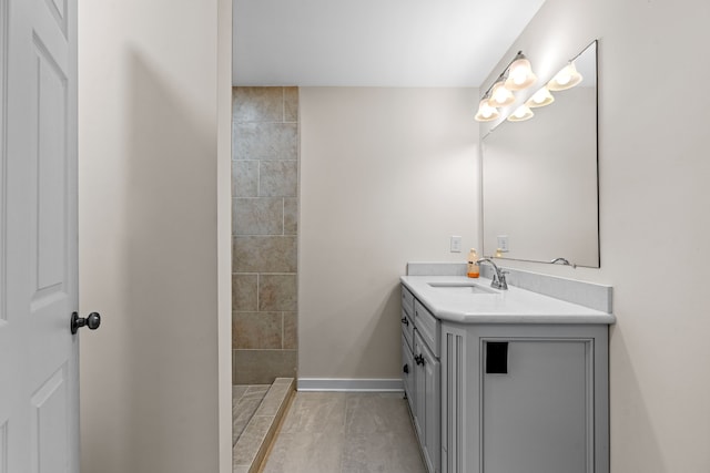 bathroom featuring vanity and tiled shower